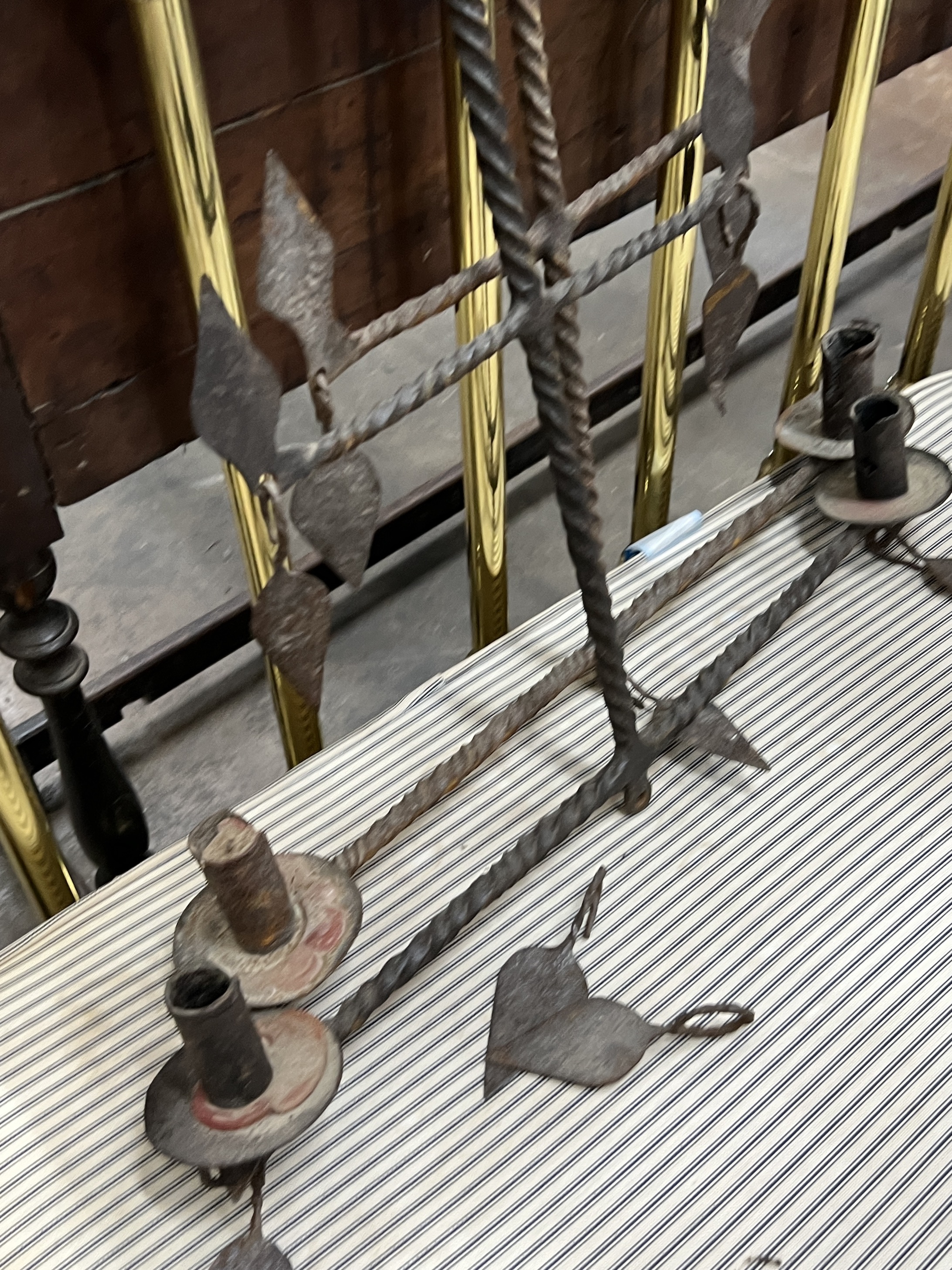 A pair of wrought iron hanging candle holders, width 64cm, height 82cm